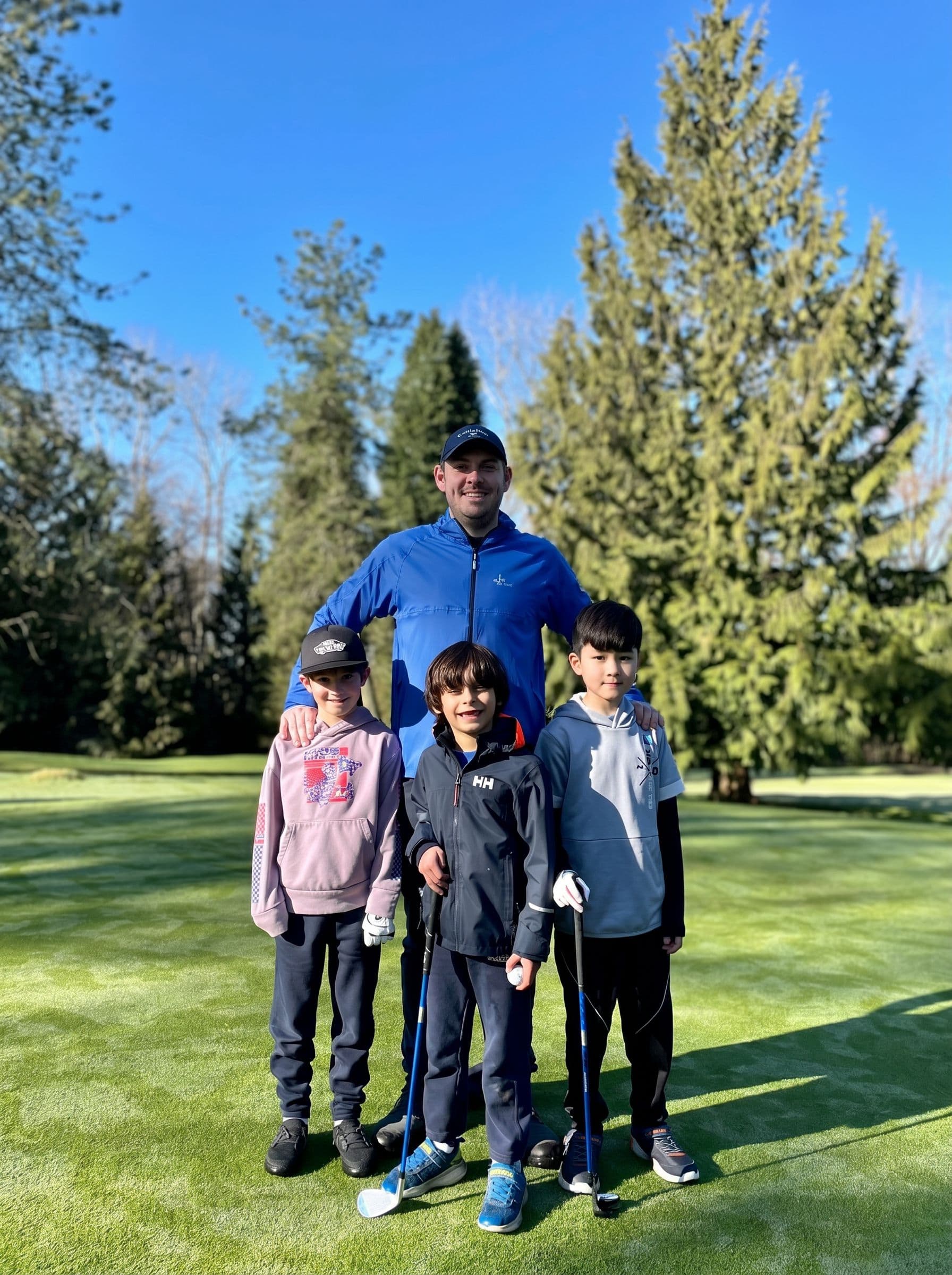 Steven Lecuyer with three junior golfers on the course